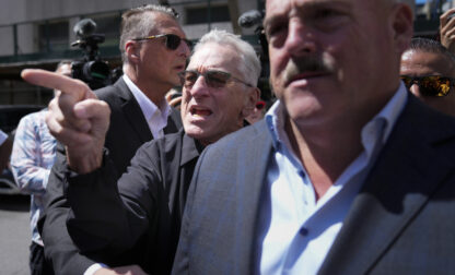 Robert De Niro, center, argues with a Donald Trump supporter after speaking to reporters in support of President Joe Biden across the street from Trump's criminal trial in New York, Tuesday, May 28, 2024. (AP Photo/Seth Wenig)