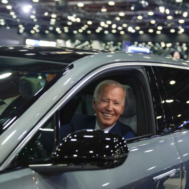 FILE - President Joe Biden drives a Cadillac Lyriq through the show room during a tour at the Detroit Auto Show, Sept. 14, 2022, in Detroit. (AP Photo/Evan Vucci, File)